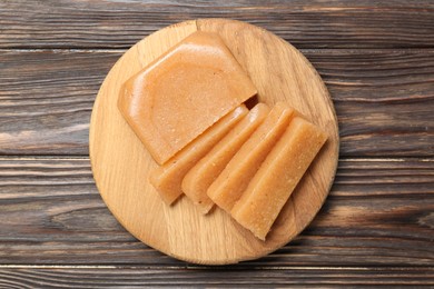 Tasty sweet quince paste on wooden table, top view