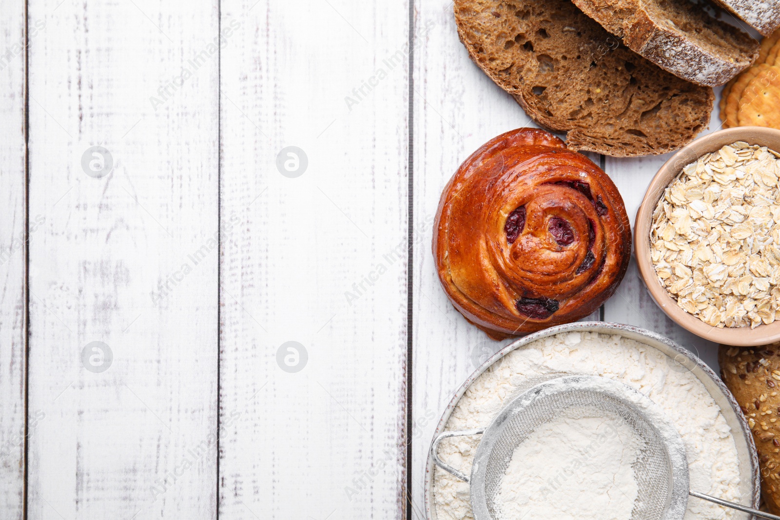 Photo of Different gluten free products on white wooden table, flat lay. Space for text