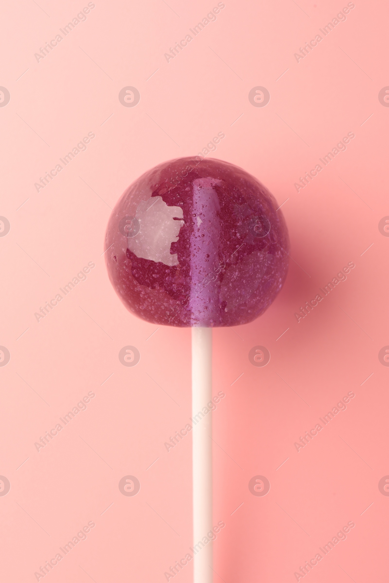 Photo of Tasty lollipop on pink background, top view