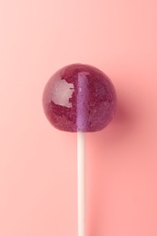 Photo of Tasty lollipop on pink background, top view