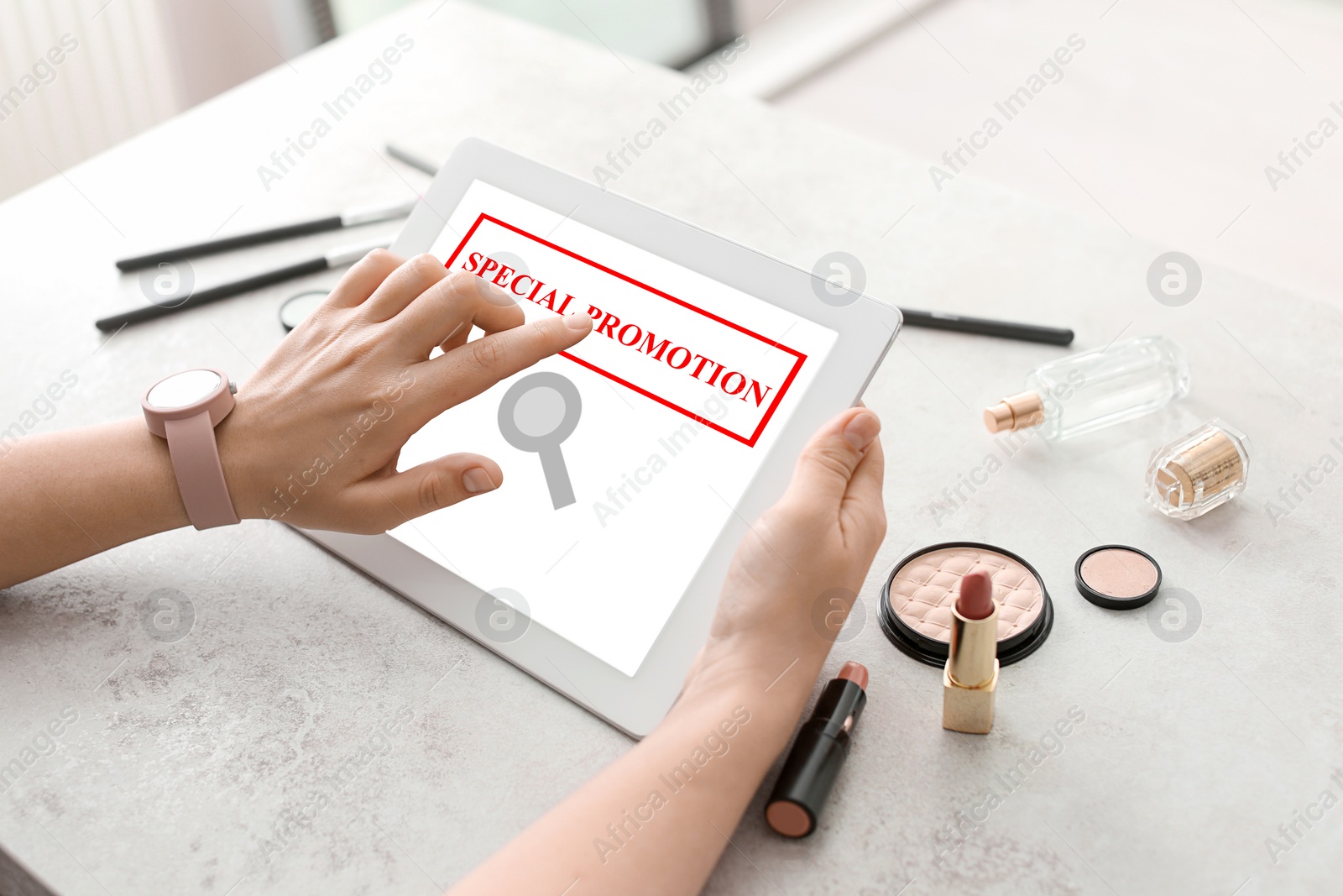 Image of Special Promotion. Young woman using tablet at table indoors, closeup