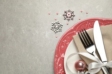 Photo of Festive table setting with beautiful dishware and Christmas decor on grey background, flat lay. Space for text