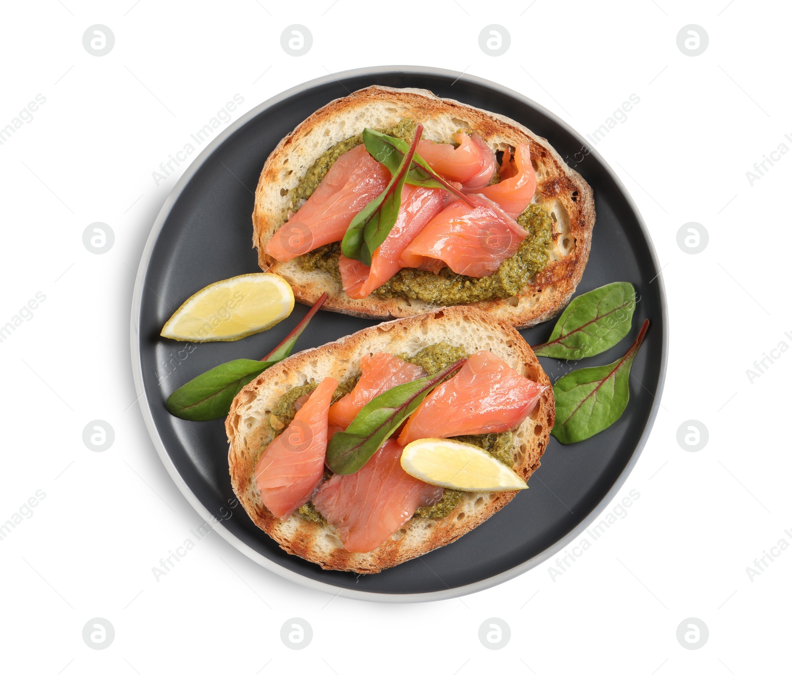 Photo of Delicious bruschettas with salmon and pesto sauce on white background, top view