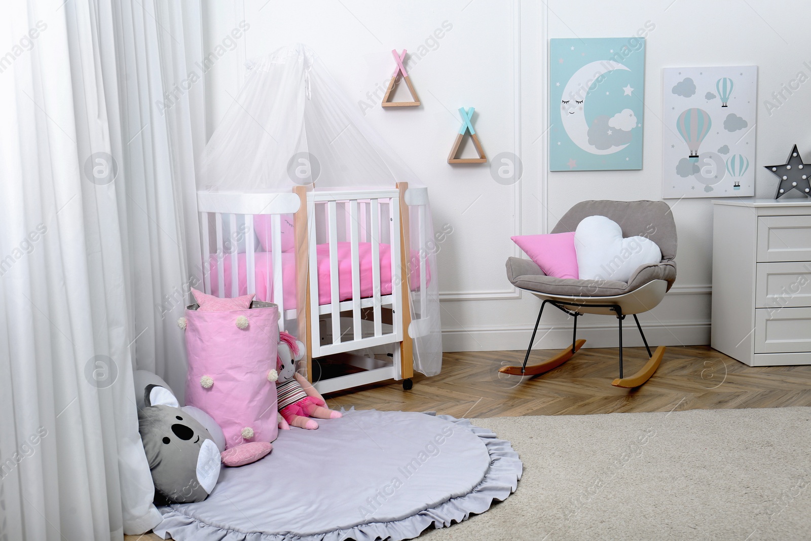 Photo of Baby room interior with toys and stylish furniture