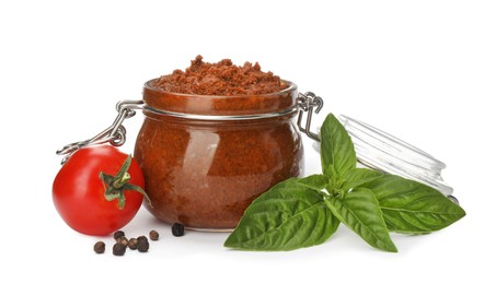 Delicious adjika sauce in glass jar and ingredients isolated on white