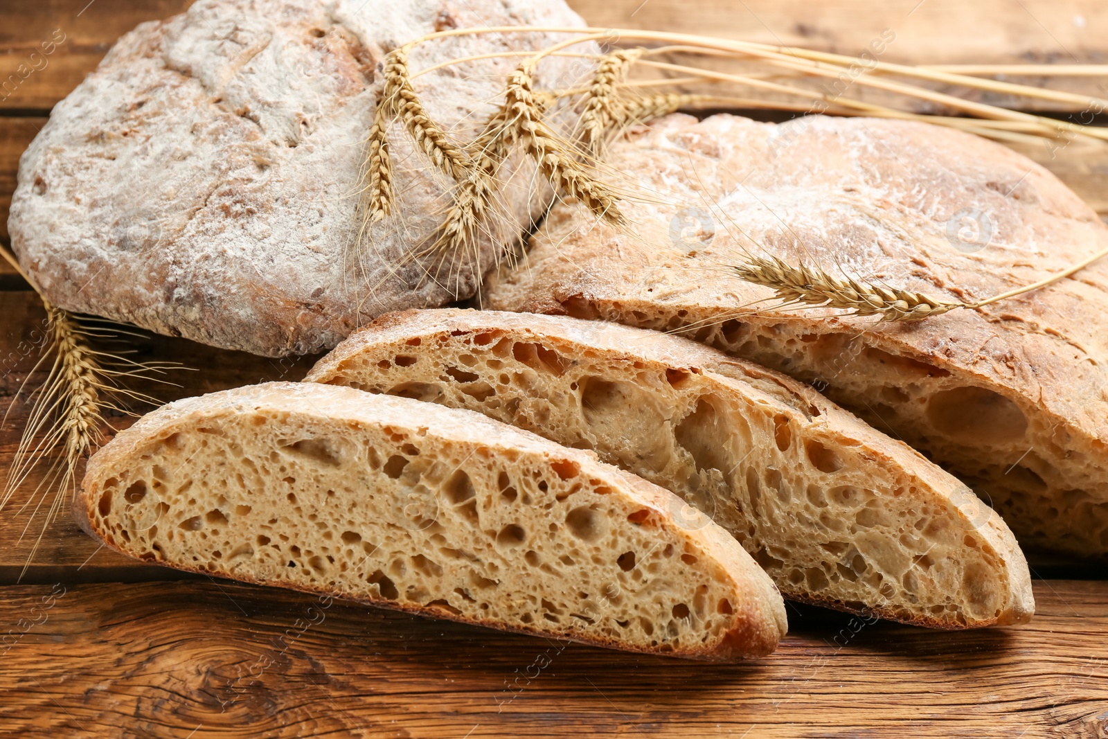 Photo of Tasty freshly baked bread on wooden table