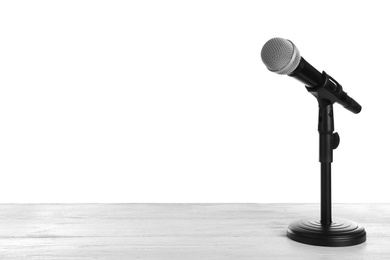 Modern microphone on table against white background. Space for text