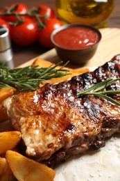 Photo of Delicious grilled ribs and garnish, closeup view