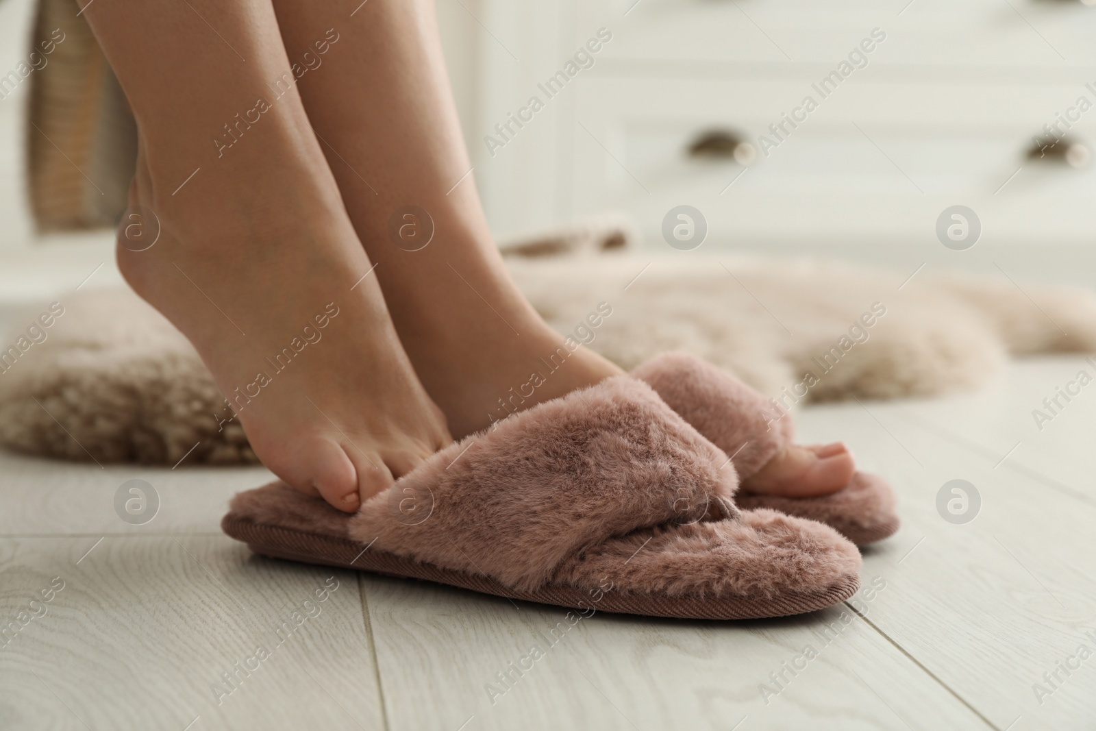 Photo of Woman in fluffy slippers at home, closeup