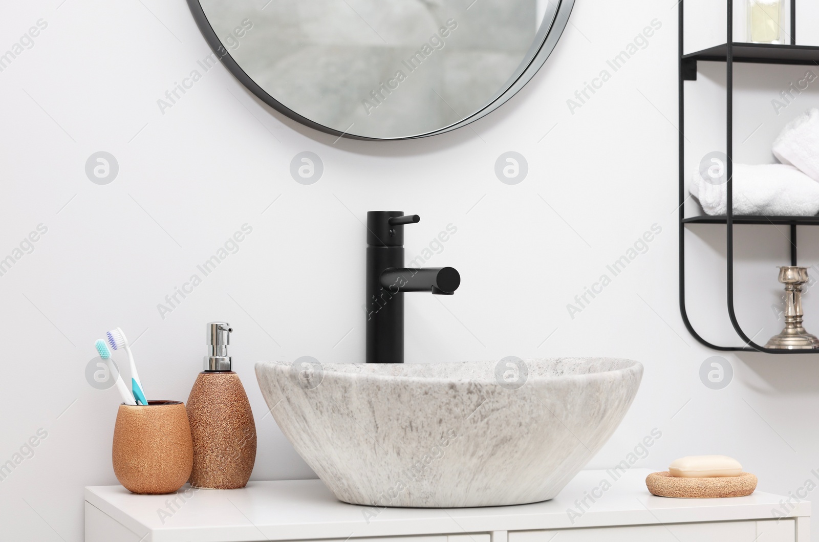 Photo of Different bath accessories and personal care products near sink on bathroom vanity