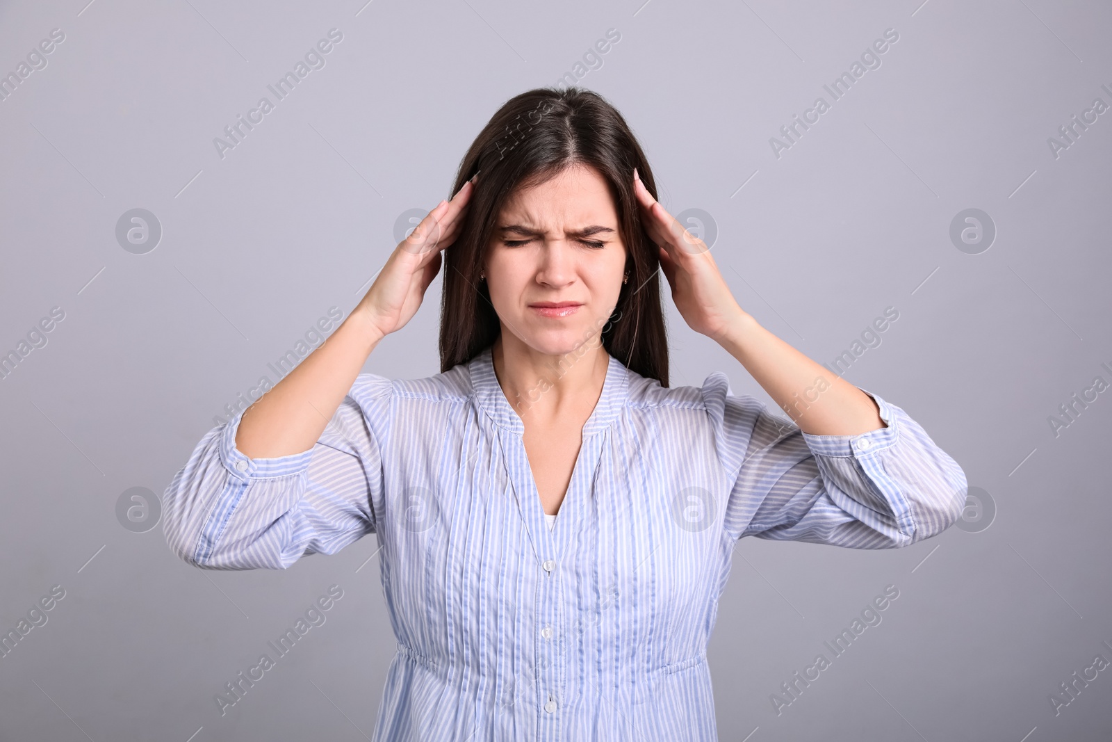 Photo of Portrait of stressed young woman on grey background