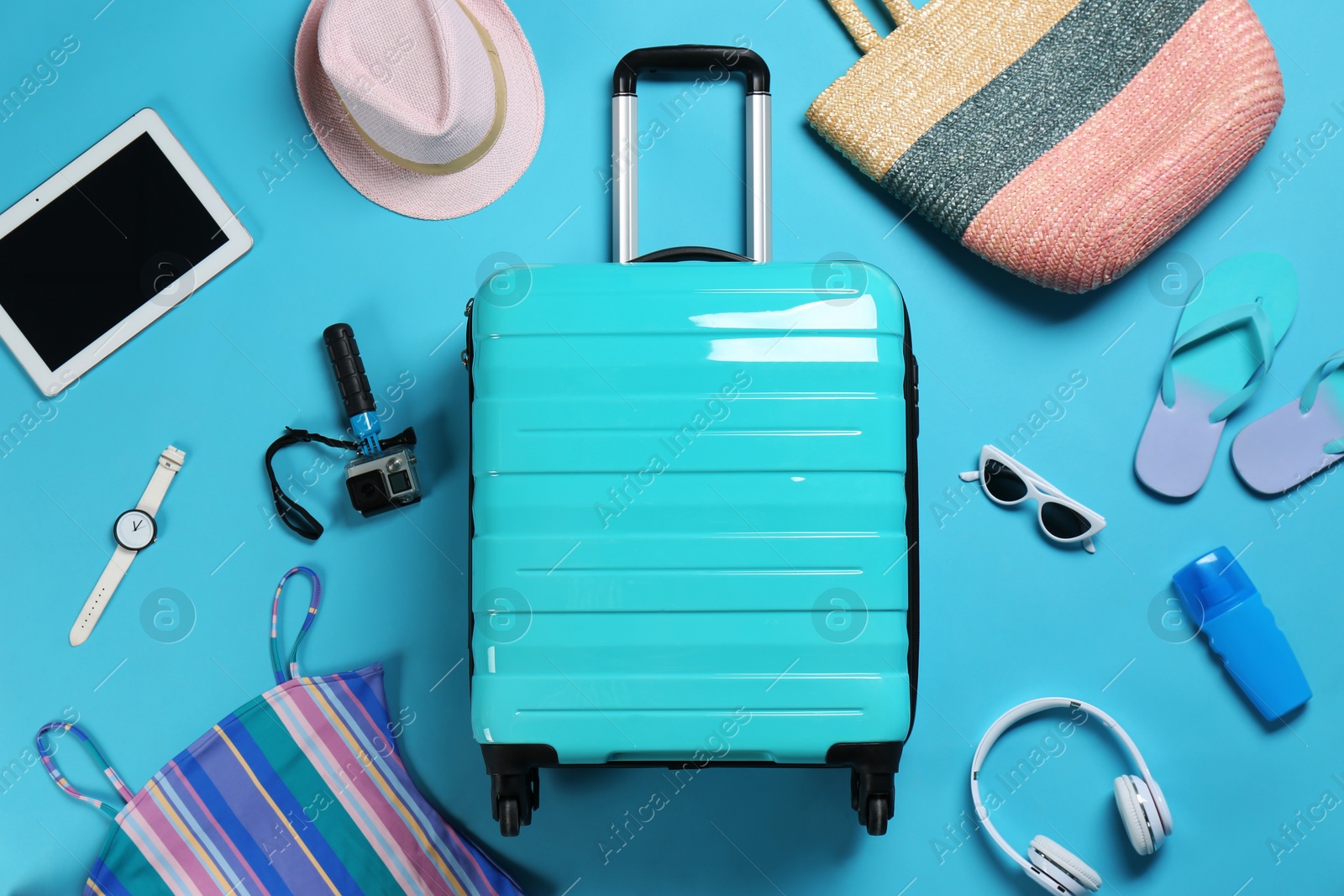 Photo of Flat lay composition with suitcase and accessories on color background, space for text. Summer vacation