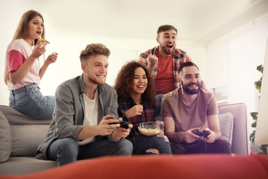 Emotional friends playing video games at home