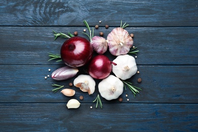 Photo of Flat lay composition with garlic and onions on wooden background