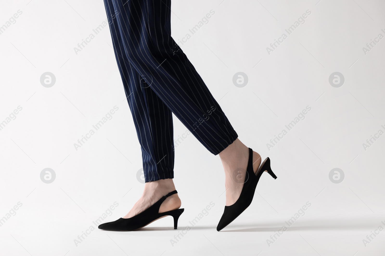 Photo of Businesswoman in black shoes on white background, closeup