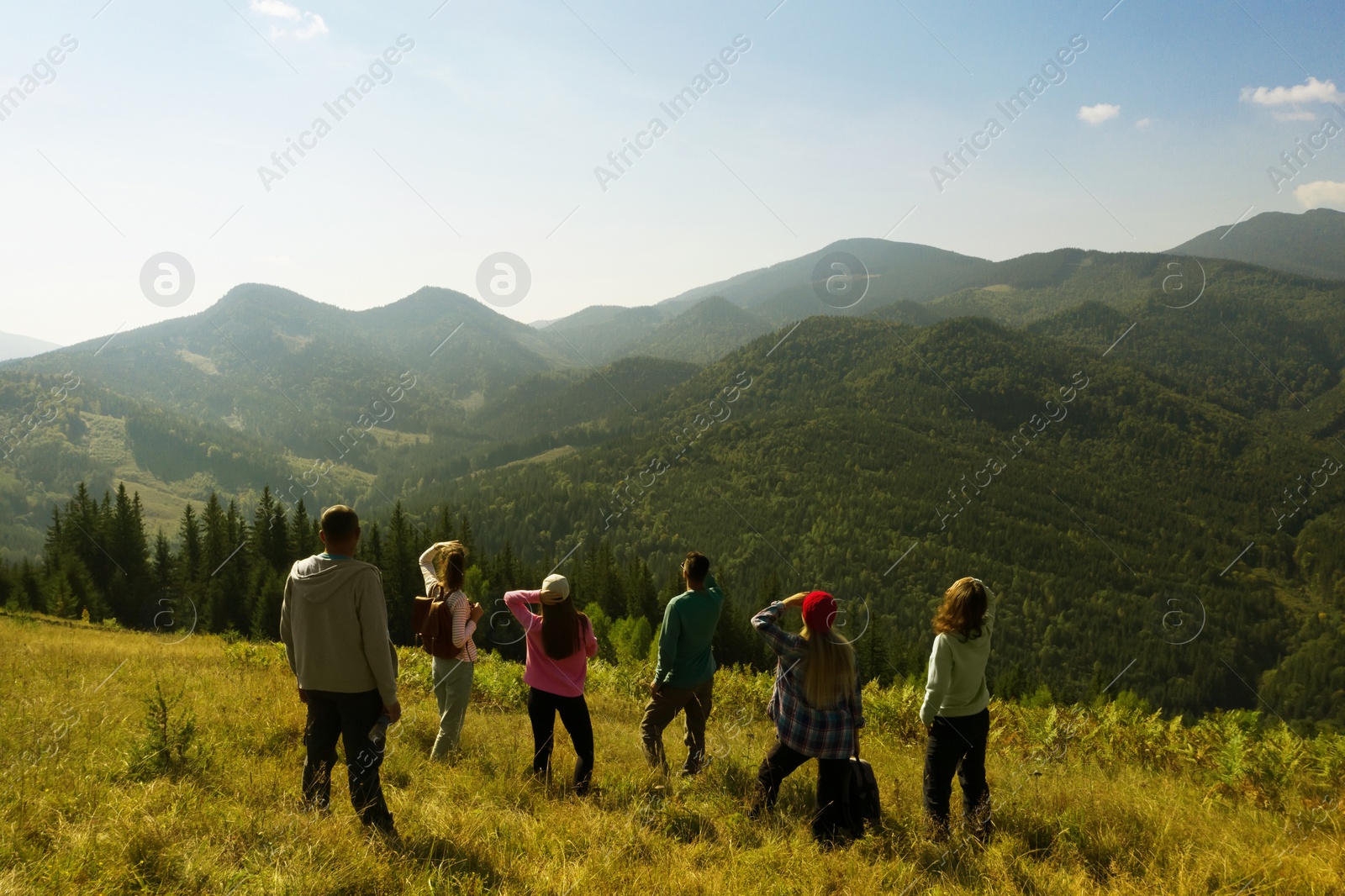 Image of Group of tourists on hill in mountains. Drone photography