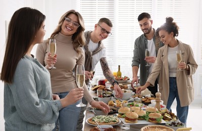 Photo of Group of people enjoying brunch buffet together indoors