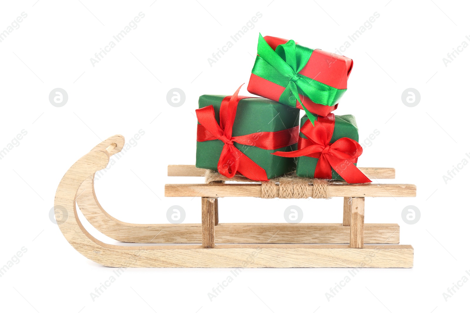 Photo of Wooden sleigh with presents on white background. Christmas holiday decor