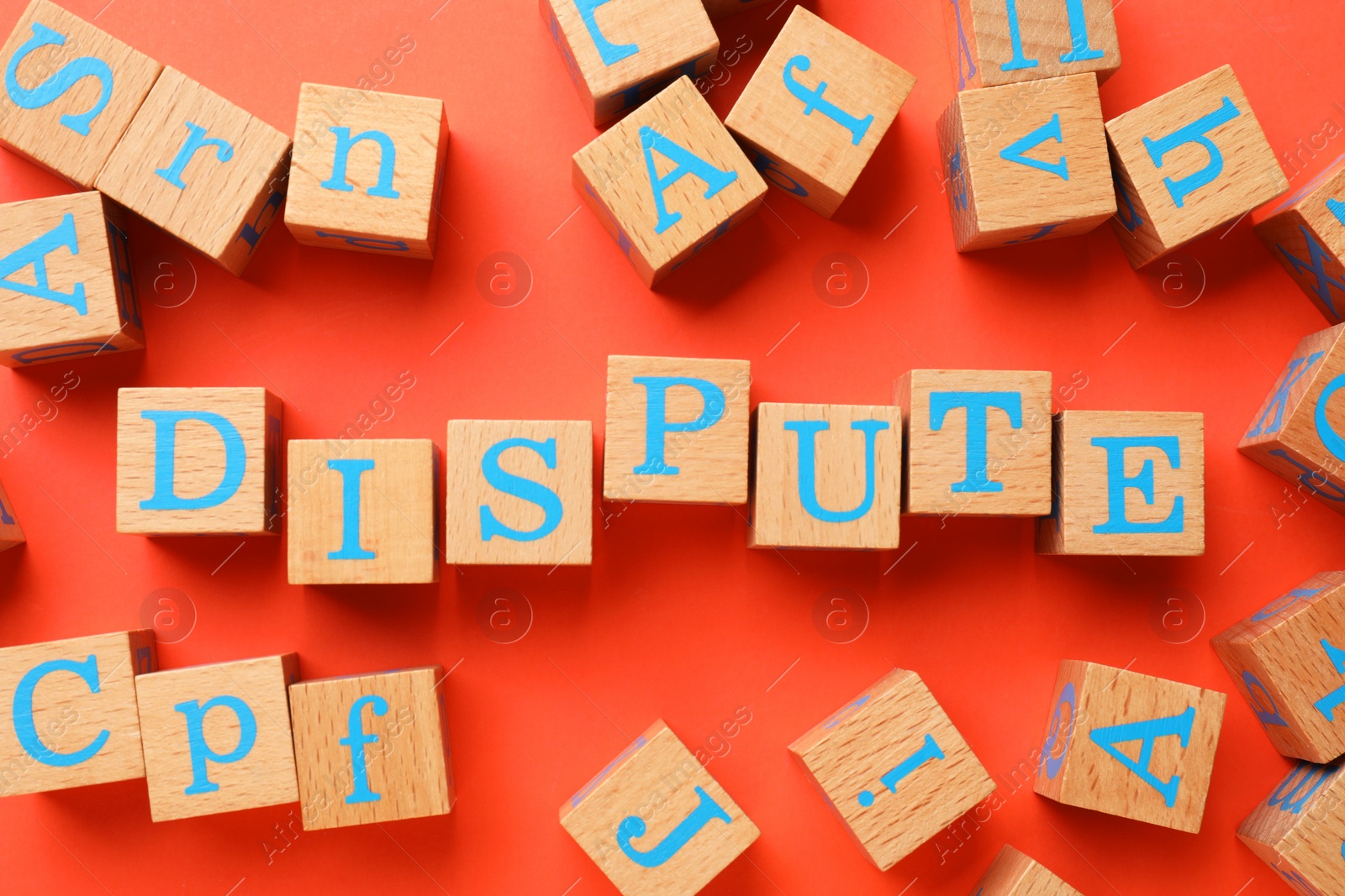 Photo of Word Dispute made with wooden cubes on red background, flat lay