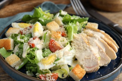 Photo of Delicious Caesar salad in bowl, closeup view