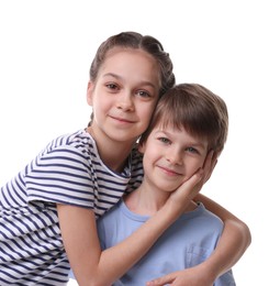 Happy brother and sister hugging on white background