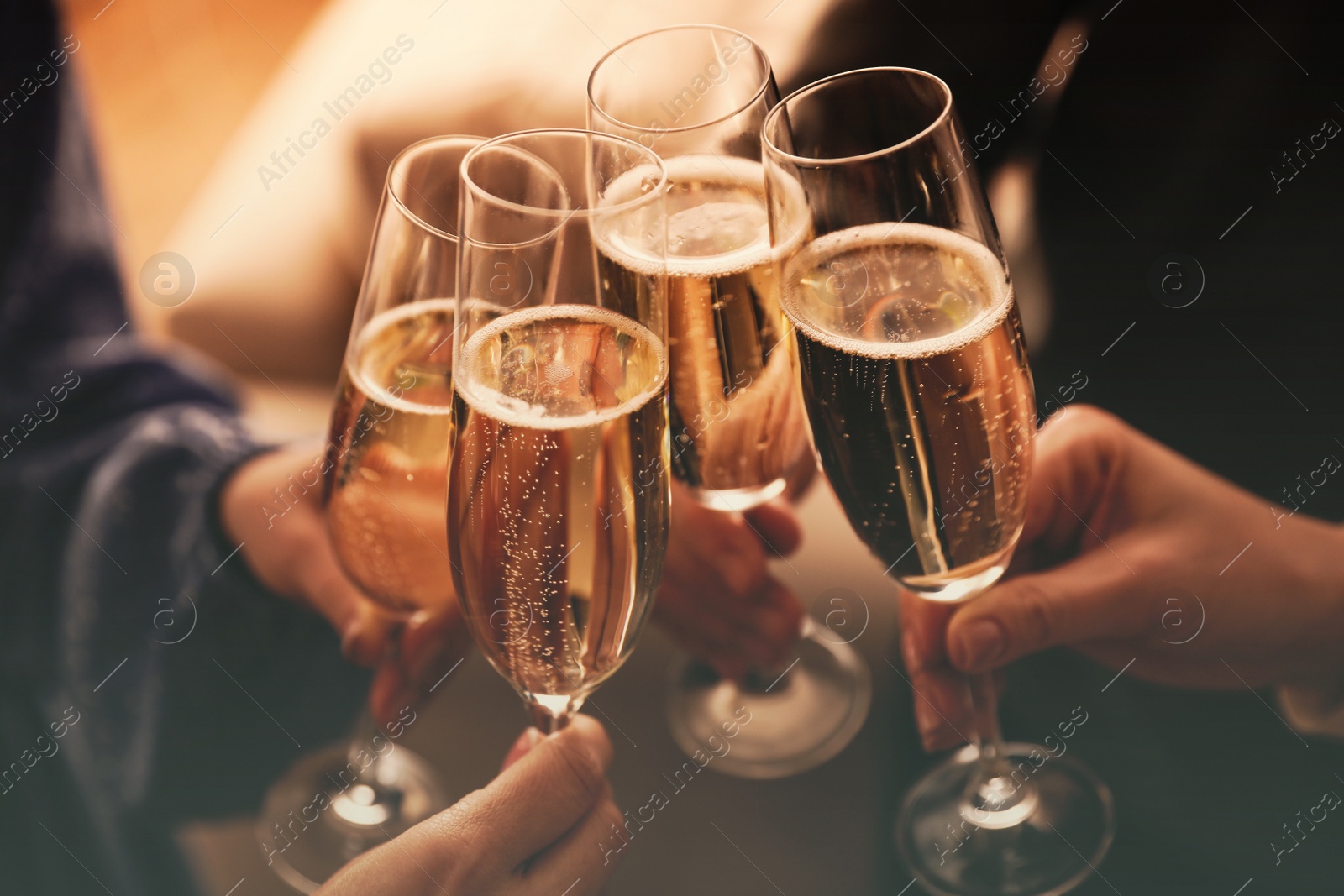 Image of People clinking glasses with sparkling wine indoors , closeup