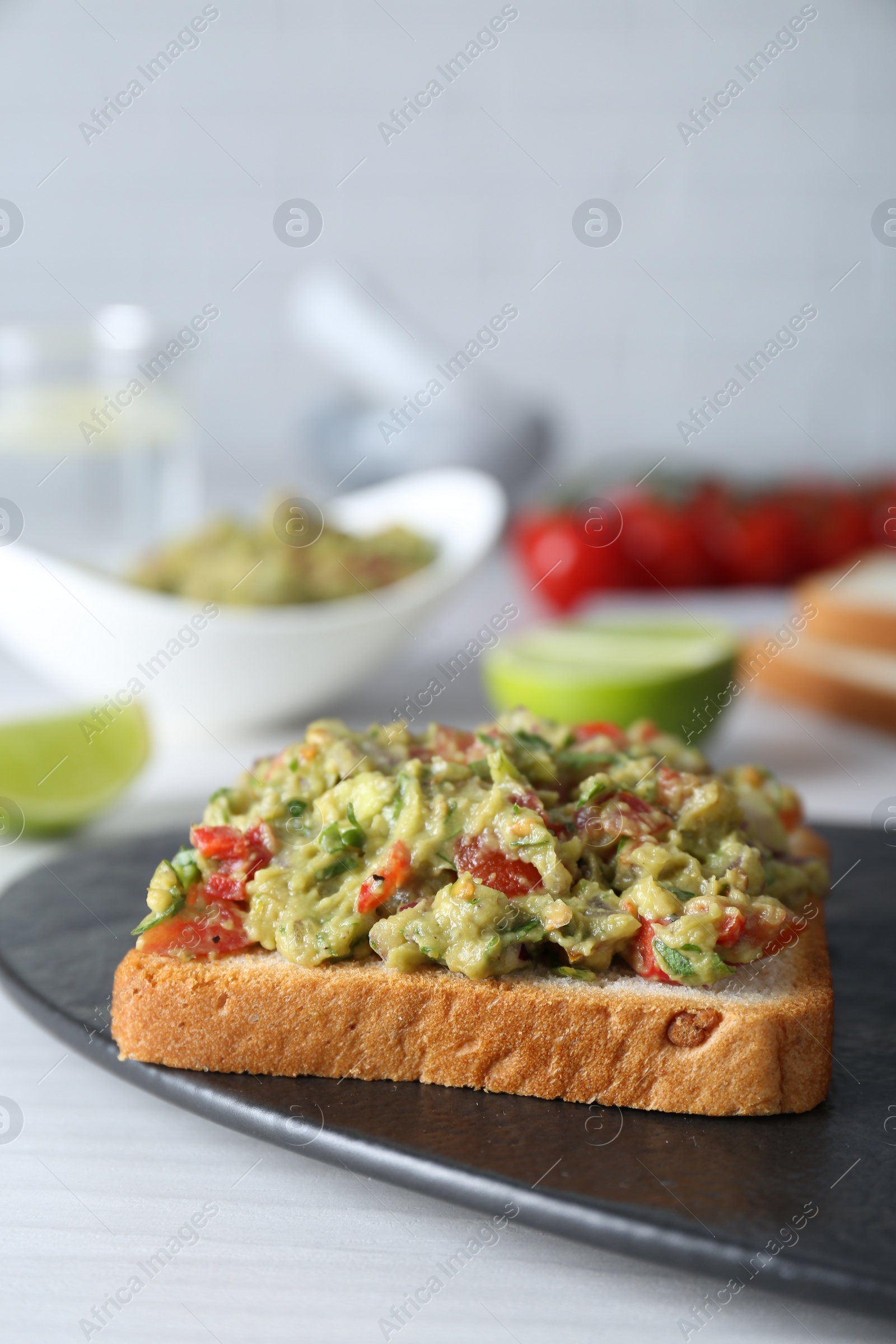 Photo of Delicious sandwich with guacamole on white table, closeup