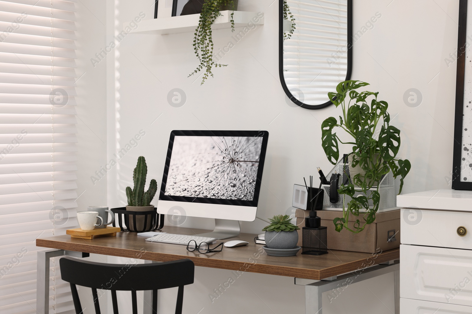 Photo of Cozy workspace with computer on wooden desk at home