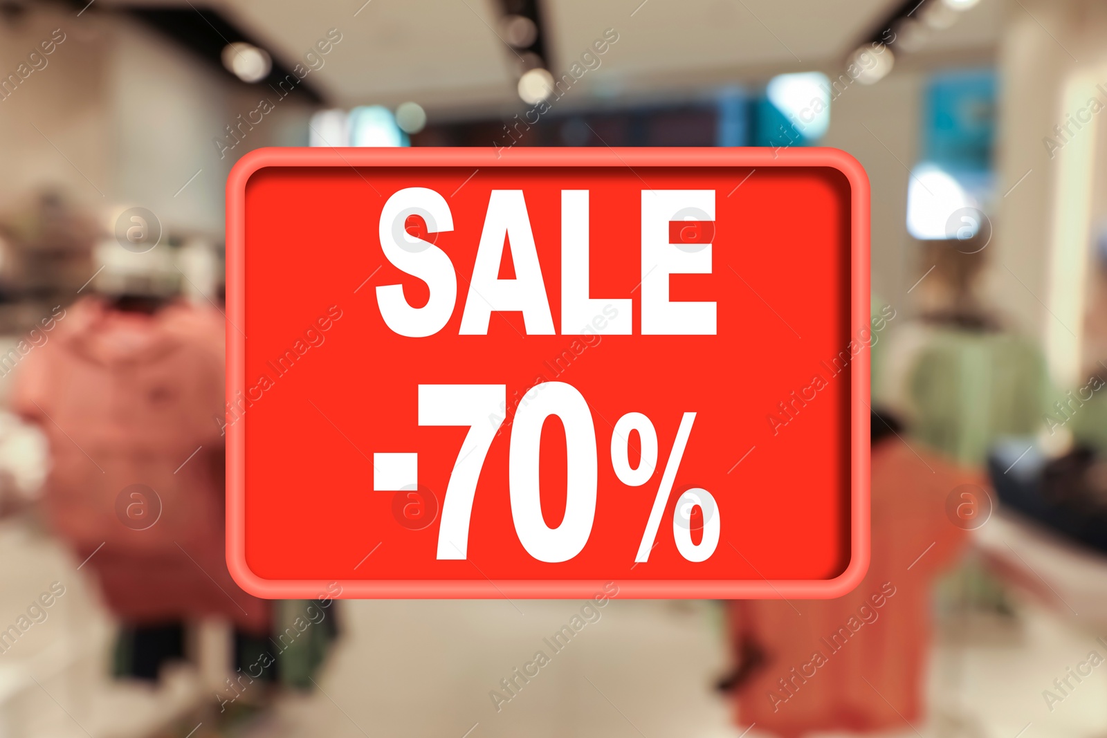 Image of Sale sign and blurred view of fashion store with clothes