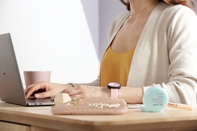 Woman using laptop at desk, closeup. Beauty blogger