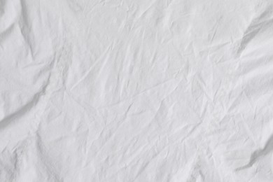 Photo of Crumpled white fabric as background, top view