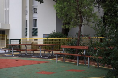 Wooden benches and tables in residential area