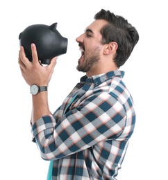 Photo of Handsome young man with piggy bank on white background