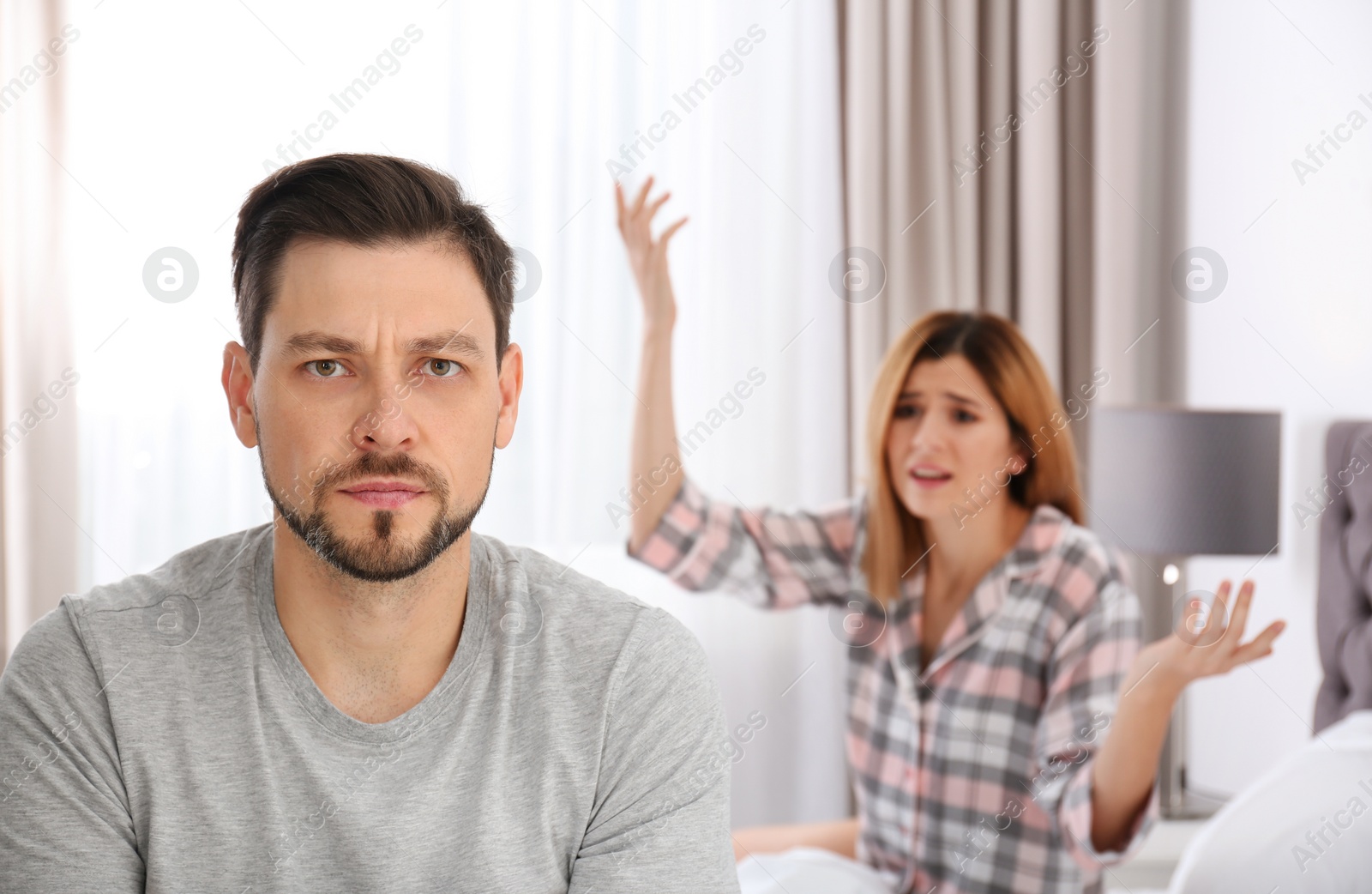 Photo of Couple having argument in bedroom. Relationship problems