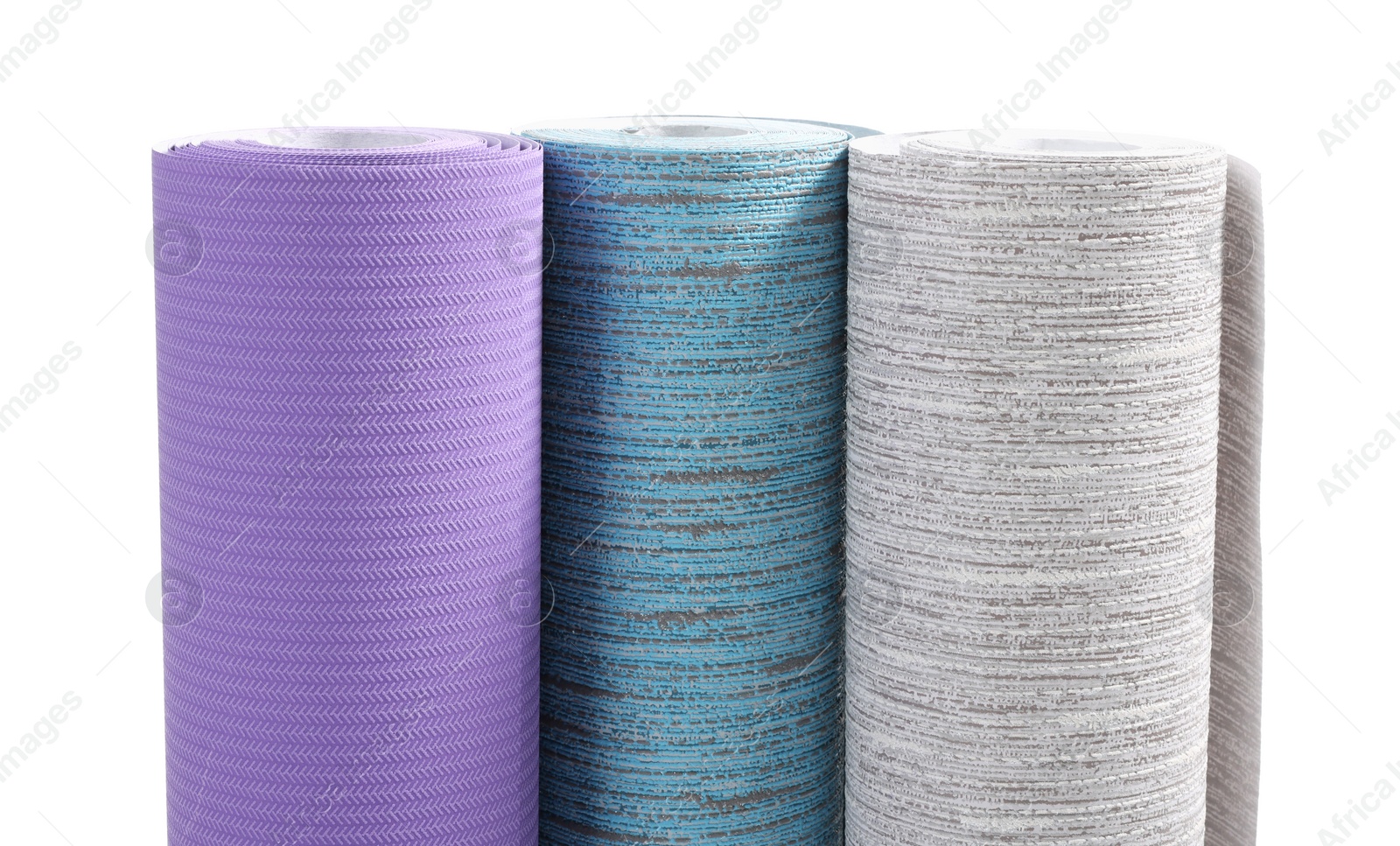 Photo of Three different wallpaper rolls isolated on white