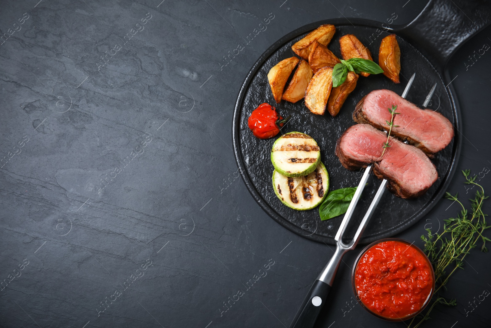 Photo of Flat lay composition with slices of grilled meat on black table. Space for text
