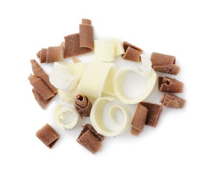 Photo of Pile of different tasty chocolate shavings isolated on white, top view