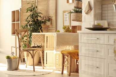 Photo of Modern kitchen interior with wooden crates as eco furniture