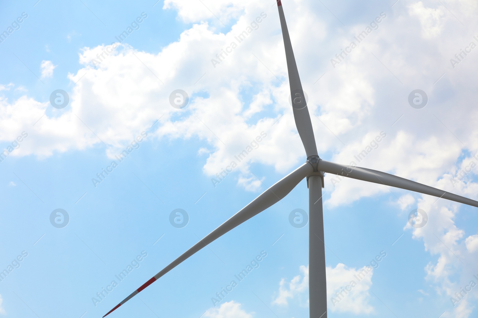 Photo of Modern wind turbine against blue sky, low angle view. Energy efficiency