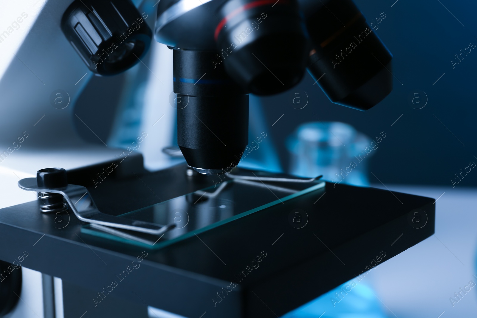 Photo of Modern microscope with different lenses, closeup. Chemical research