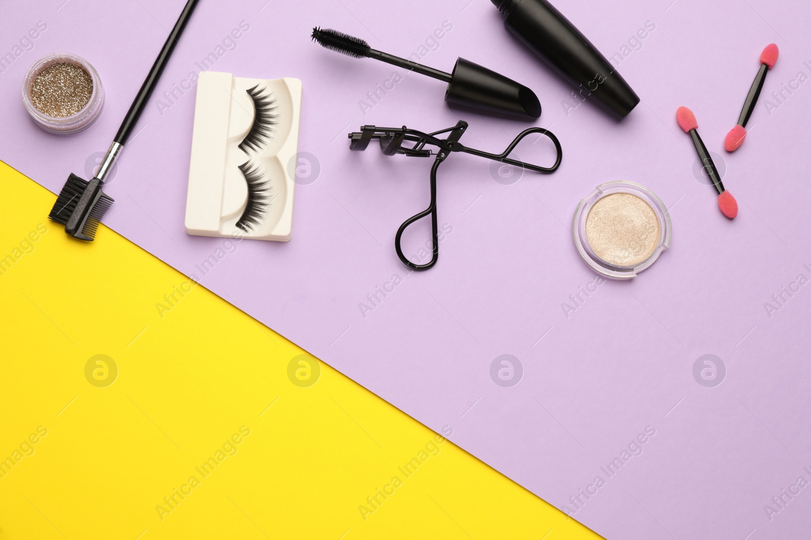 Photo of Flat lay composition with eyelash curler, makeup products and accessories on color background. Space for text