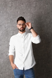 Photo of Portrait of handsome man in glasses on grey background