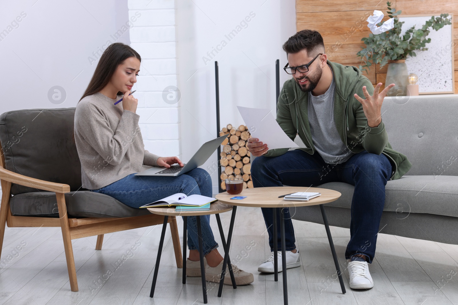 Photo of Young couple discussing family budget at home