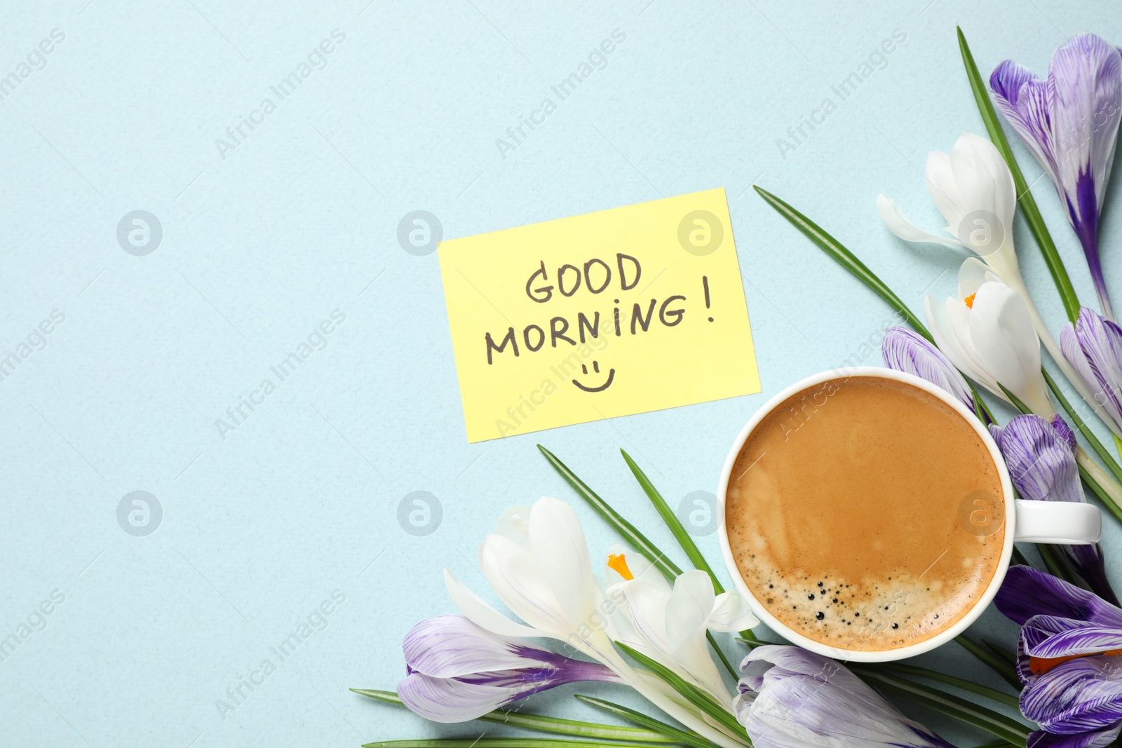 Photo of Delicious coffee, flowers and card with GOOD MORNING wish on light background, flat lay. Space for text