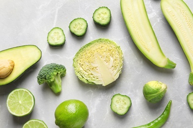 Flat lay composition with fresh vegetables and fruits on light background