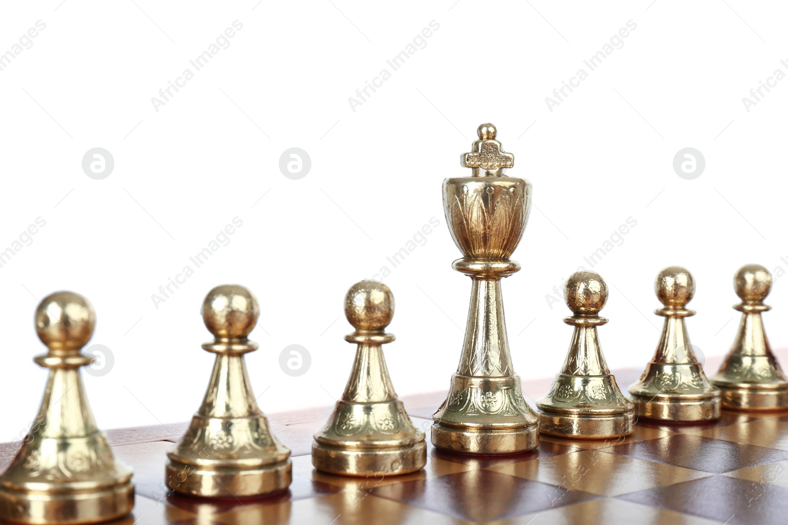 Photo of King among pawns on wooden chess board against white background