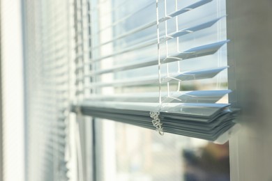 Photo of Stylish window with horizontal blinds indoors, closeup. Space for text