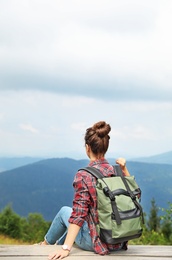 Photo of Woman with backpack in wilderness on cloudy day