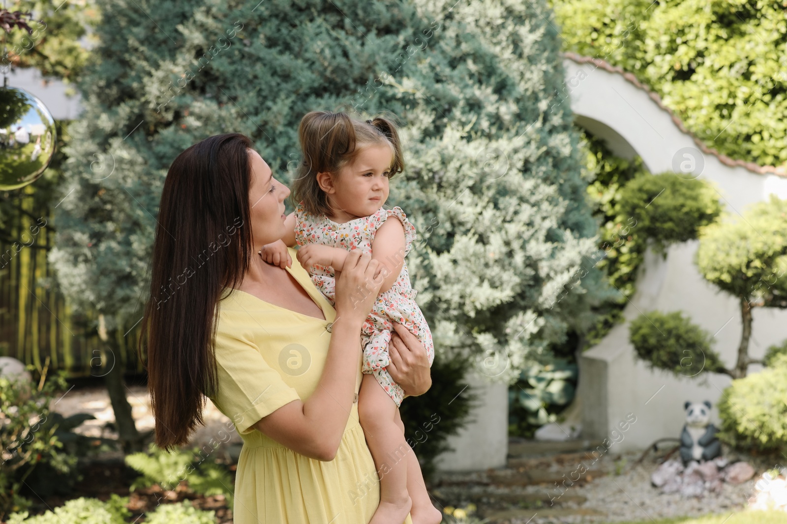 Photo of Mother with her cute daughter spending time together in park