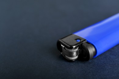 Photo of Stylish small pocket lighter on black background, closeup. Space for text